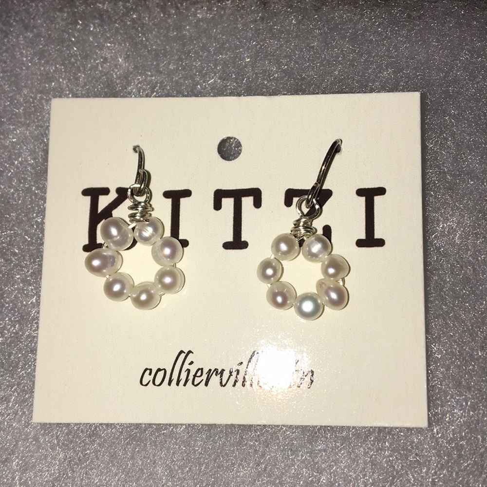 layered pearl oval earrings.